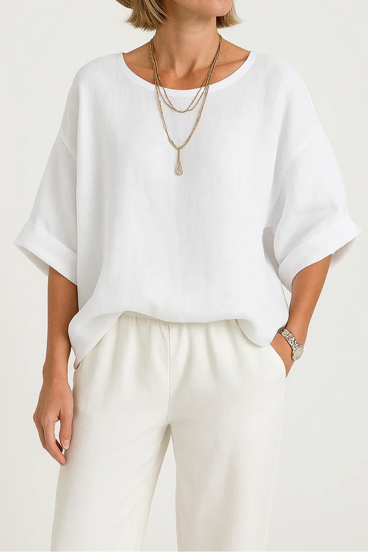 Woman wearing a white top and beige hat on a plain background