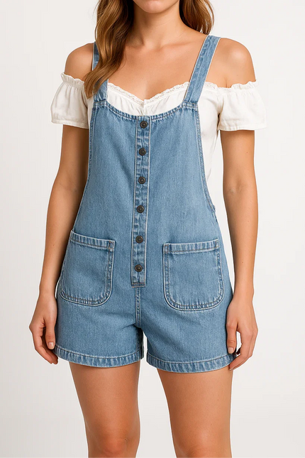 Woman wearing a denim overall romper on a white background