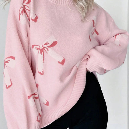 Person wearing a pink sweater with red patterns on a plain background