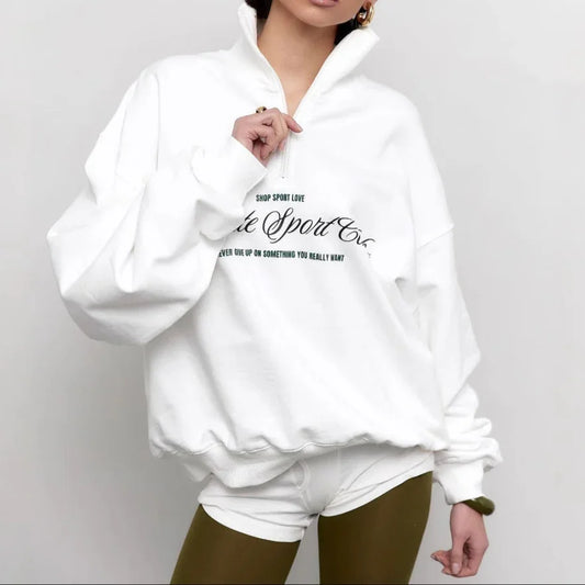 Woman wearing a white hoodie with text on a plain background