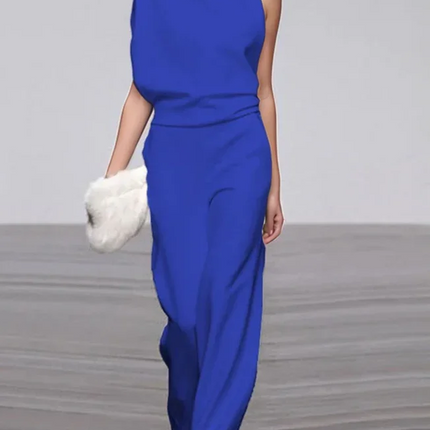 Woman wearing a blue outfit on a plain background