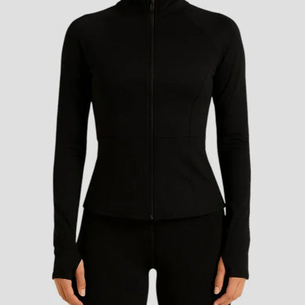 Woman wearing a black zip-up athletic jacket on a light gray background