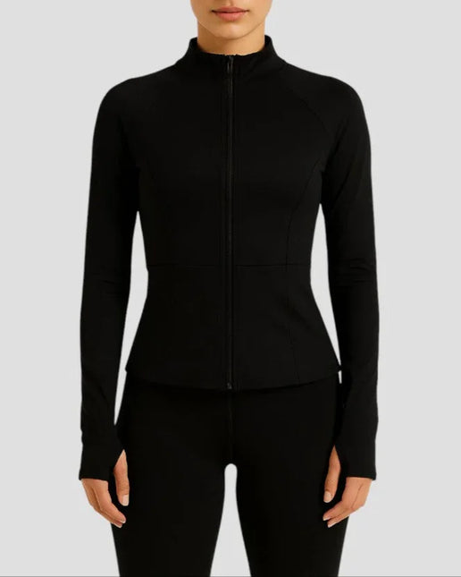 Woman wearing a black zip-up athletic jacket on a light gray background