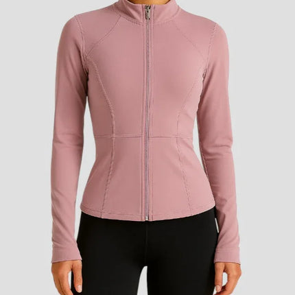 Woman wearing a pink jacket on a light gray background