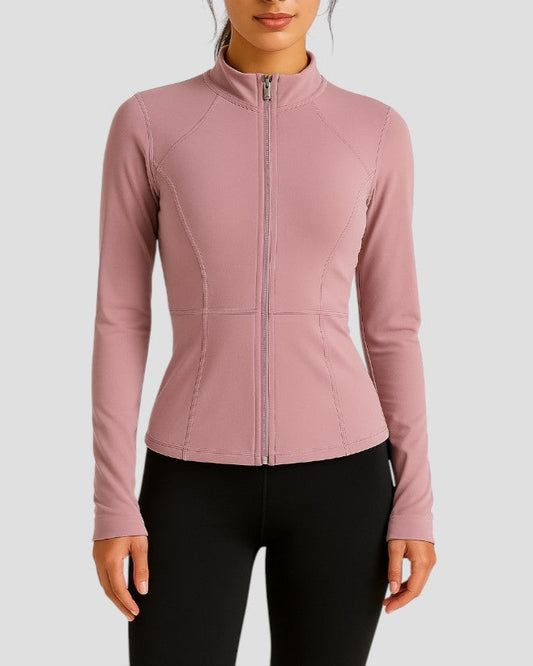 Woman wearing a pink jacket on a light gray background