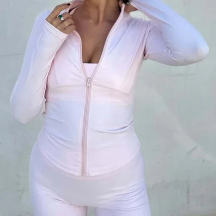Woman wearing a light pink outfit against a plain background