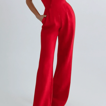 Woman wearing a red jumpsuit against a white background