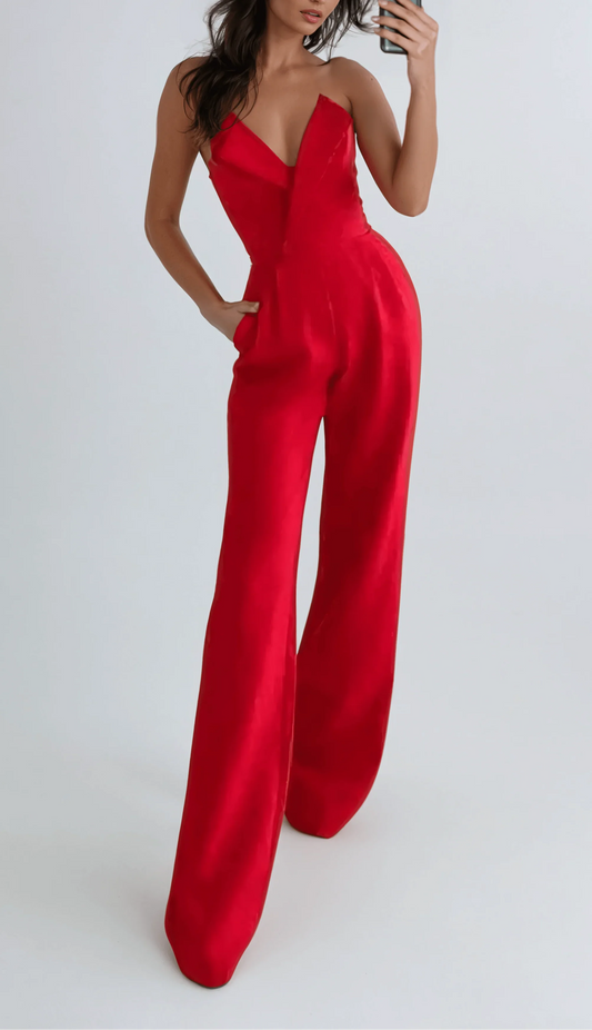 Woman wearing a red jumpsuit against a white background